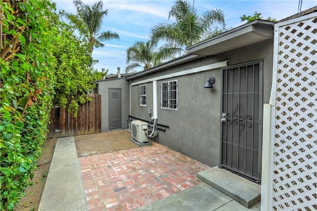 exterior space with ac unit and fence