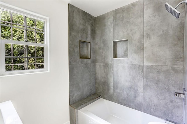 bathroom with a shower, baseboards, and a tub to relax in