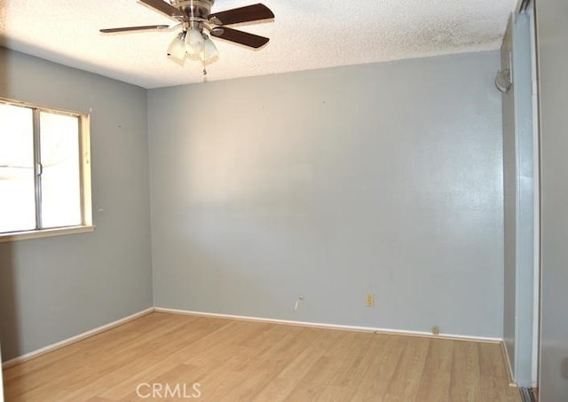 unfurnished room featuring ceiling fan, a textured ceiling, and light hardwood / wood-style flooring