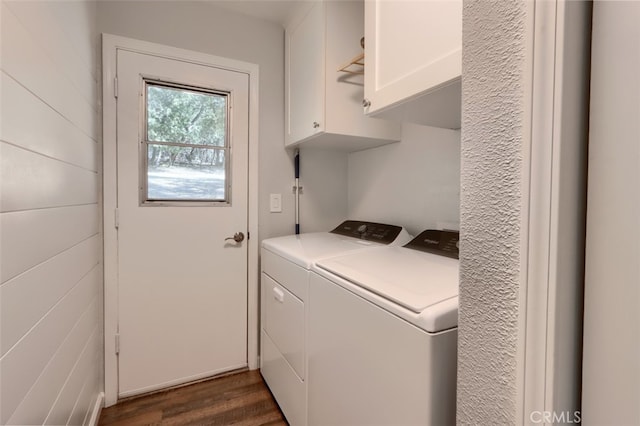 laundry area with independent washer and dryer, cabinets, and dark hardwood / wood-style floors