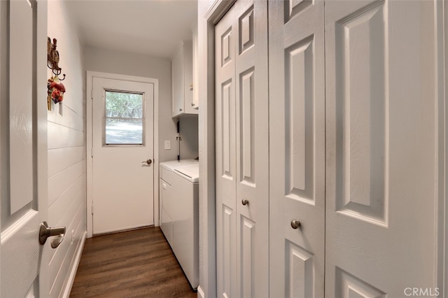 clothes washing area featuring cabinets, washing machine and dryer, and dark hardwood / wood-style flooring