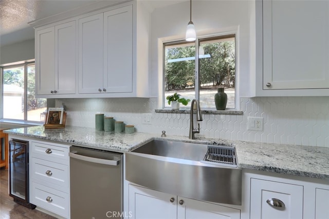 kitchen with white cabinets, beverage cooler, dishwasher, pendant lighting, and sink