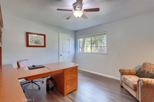 office space with ceiling fan, a textured ceiling, and dark hardwood / wood-style flooring