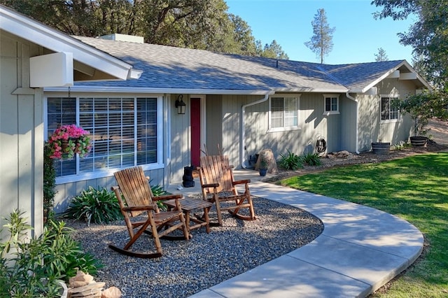 exterior space with a front yard and a patio area