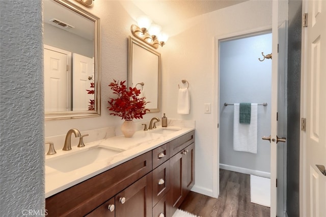 bathroom with vanity and hardwood / wood-style floors