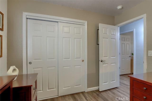 bedroom with a closet and light wood-type flooring