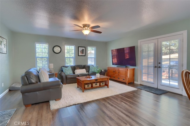 living room featuring french doors, wood-type flooring, and plenty of natural light