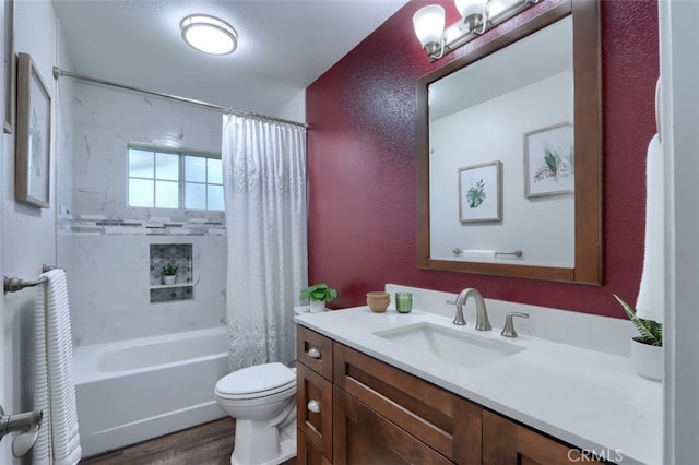 full bathroom with toilet, shower / bath combination with curtain, wood-type flooring, vanity, and a textured ceiling