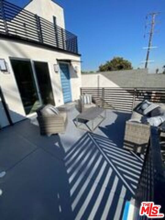 exterior space featuring a balcony and outdoor lounge area