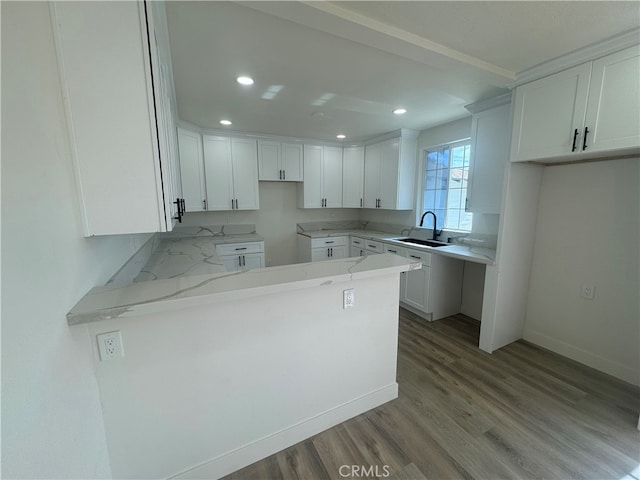 kitchen featuring white cabinetry, light stone counters, and light hardwood / wood-style floors