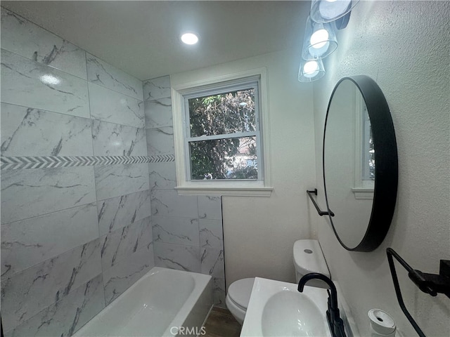 full bathroom with toilet, sink, and tiled shower / bath