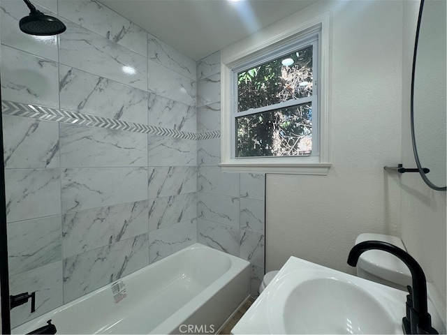 bathroom with vanity and tiled shower / bath combo