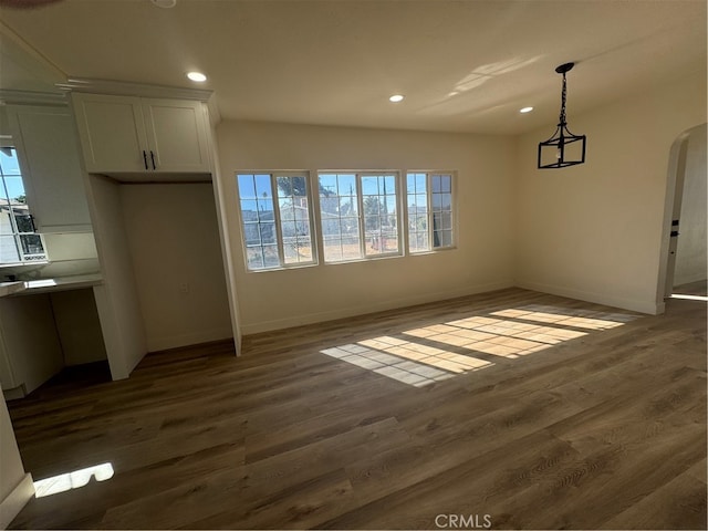 unfurnished dining area with dark hardwood / wood-style flooring