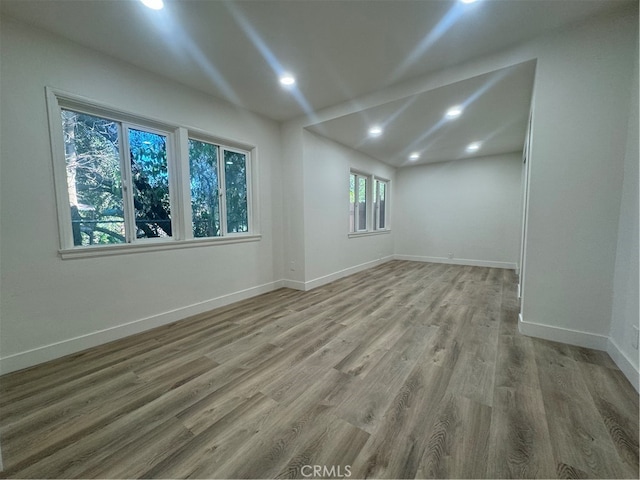 unfurnished room with hardwood / wood-style floors