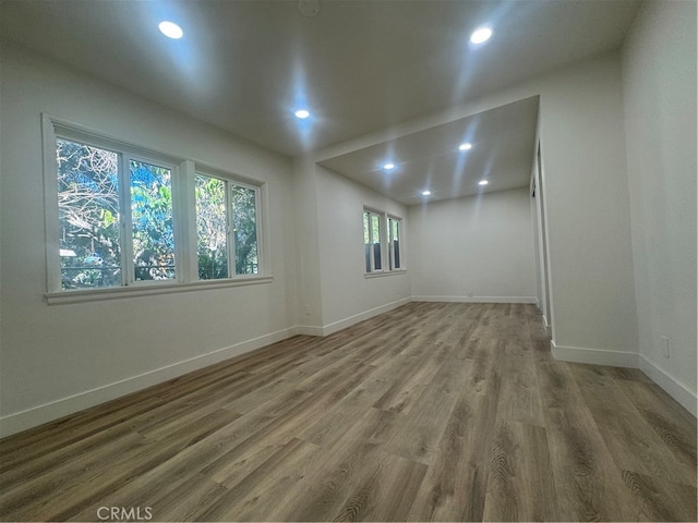 unfurnished room with hardwood / wood-style floors