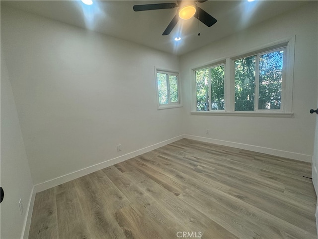 empty room featuring ceiling fan and light wood-type flooring