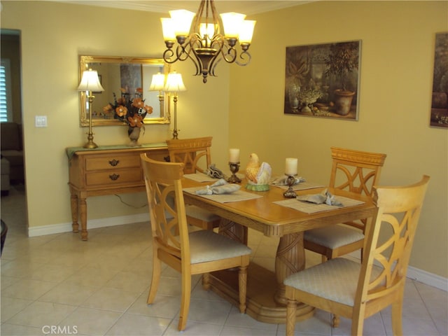 dining room with ornamental molding, a notable chandelier, and light tile patterned floors