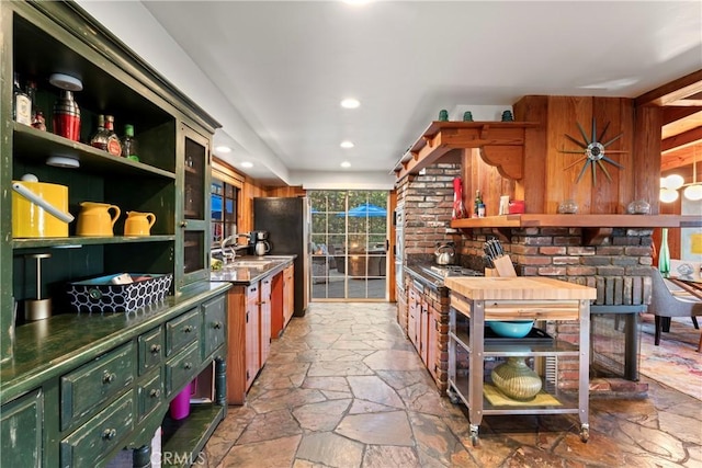 309 Castle Gate Rd, Lake Arrowhead, CA 92352 - kitchen with stone floors, open shelves, freestanding refrigerator, recessed lighting, and dark countertops