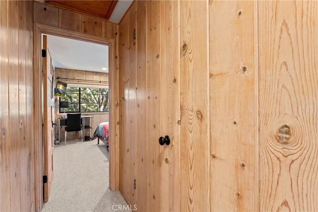 309 Castle Gate Rd, Lake Arrowhead, CA 92352 - hallway featuring wooden walls and light colored carpet
