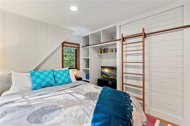 bedroom with a fireplace and hardwood / wood-style flooring