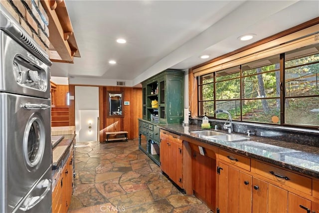 kitchen featuring dark stone countertops and sink