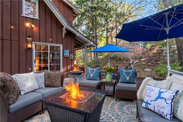 view of patio / terrace featuring an outdoor living space with a fire pit