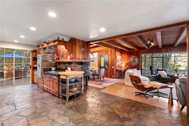 309 Castle Gate Rd, Lake Arrowhead, CA 92352 - kitchen with wooden walls, stone finish floors, a wooden ceiling with exposed beams, recessed lighting, and open floor plan