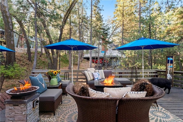 wooden deck with an outdoor living space with a fire pit