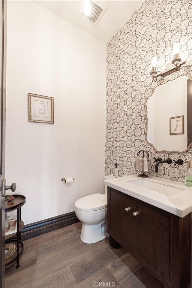 bathroom featuring hardwood / wood-style floors, vanity, and toilet