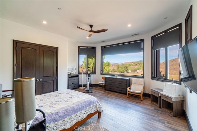 bedroom featuring dark hardwood / wood-style flooring and ceiling fan