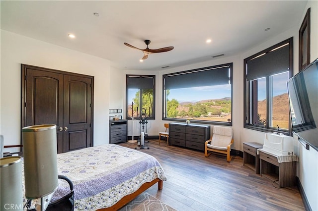bedroom featuring baseboards, ceiling fan, recessed lighting, and wood finished floors