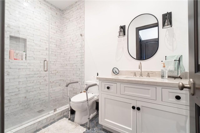 bathroom featuring a shower with door, vanity, and toilet