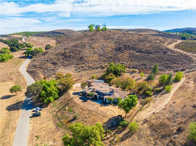 birds eye view of property with a mountain view