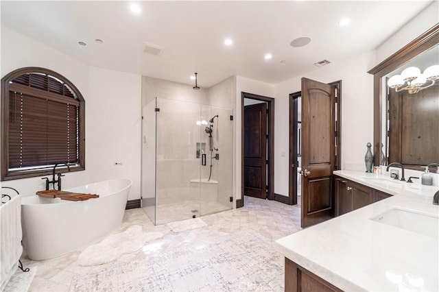 bathroom with vanity and shower with separate bathtub