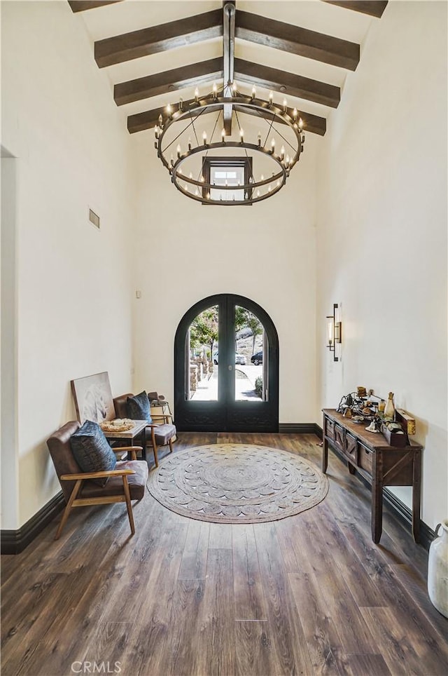 entrance foyer featuring french doors, beam ceiling, high vaulted ceiling, a notable chandelier, and dark hardwood / wood-style floors