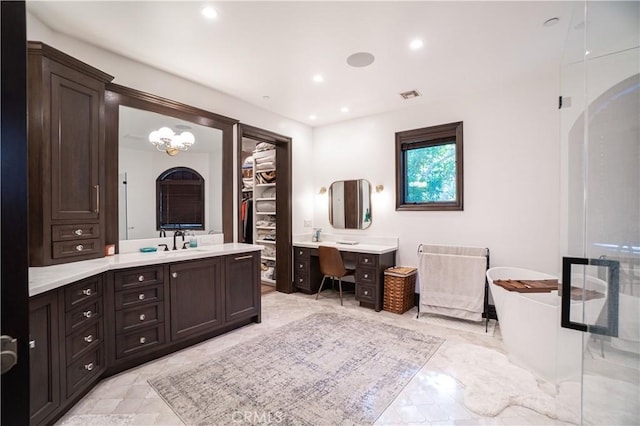 bathroom with visible vents, two vanities, a soaking tub, and marble finish floor