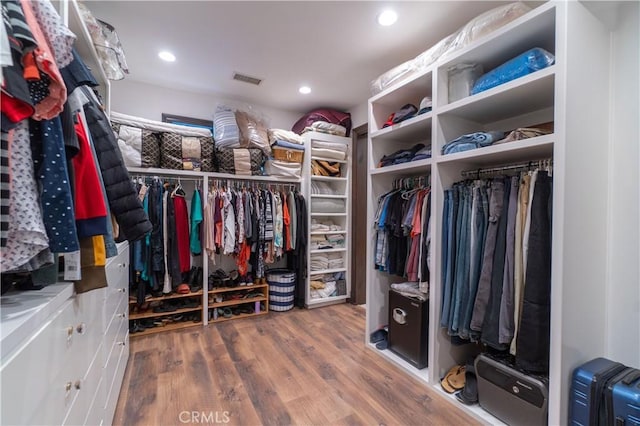 walk in closet with wood finished floors and visible vents