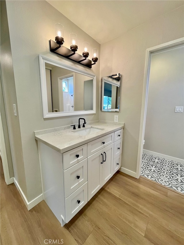 bathroom with vanity and wood-type flooring