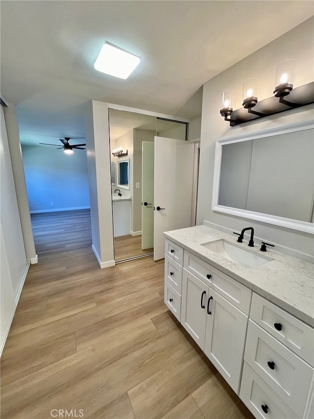 bathroom with vanity, ceiling fan, and hardwood / wood-style floors