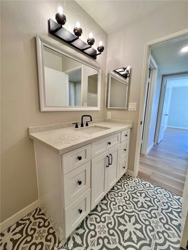 bathroom with vanity and hardwood / wood-style flooring