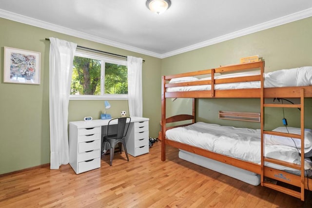 bedroom featuring ornamental molding and light hardwood / wood-style floors