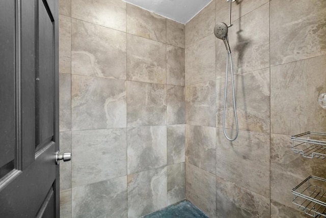 bathroom with tiled shower