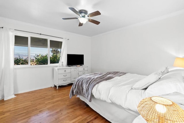 bedroom featuring crown molding, hardwood / wood-style floors, and ceiling fan