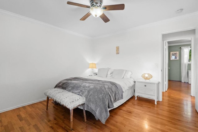 bedroom featuring light hardwood / wood-style flooring, ornamental molding, and ceiling fan