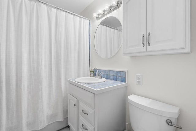 bathroom with vanity, toilet, and curtained shower