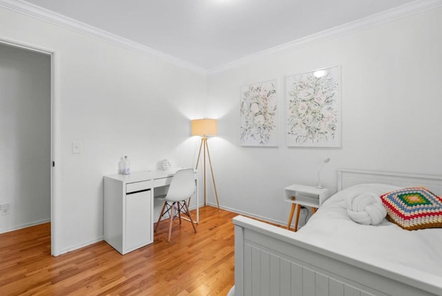 bedroom featuring ornamental molding and light hardwood / wood-style floors