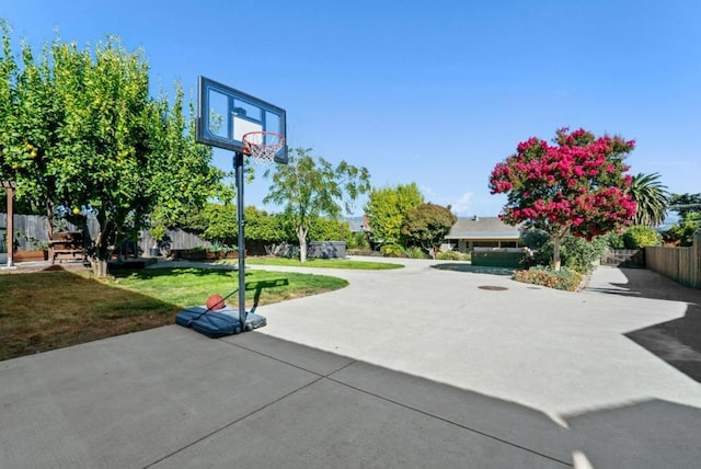 view of sport court with a yard