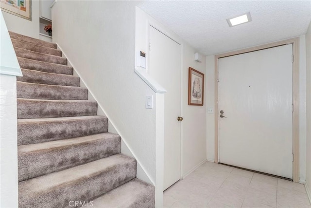 foyer entrance featuring a textured ceiling