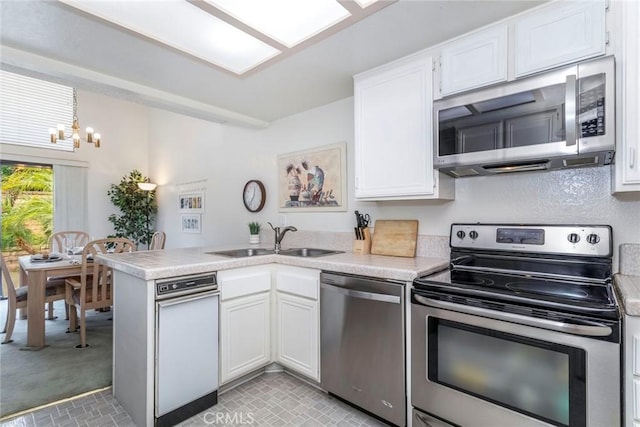 kitchen with white cabinets, sink, and appliances with stainless steel finishes