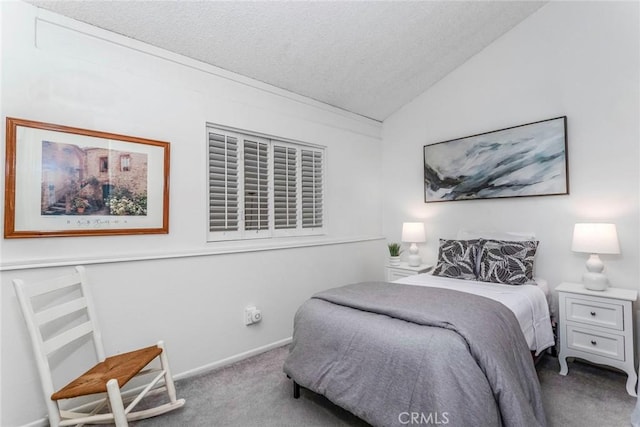 bedroom with a textured ceiling, light carpet, and vaulted ceiling